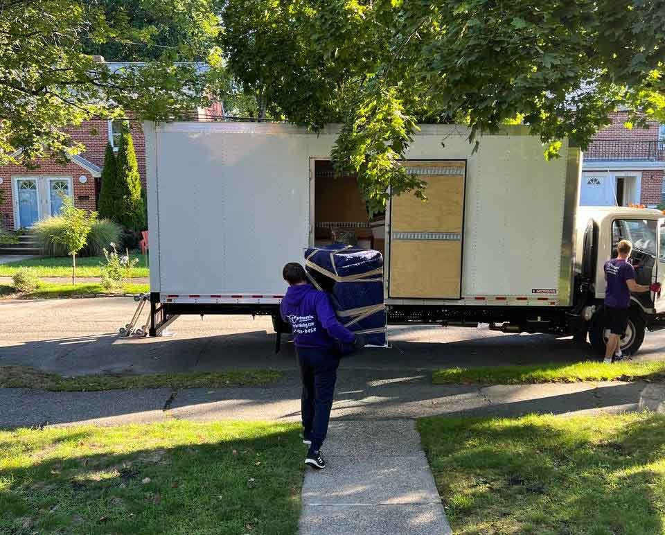 Mover carrying furniture to the truck