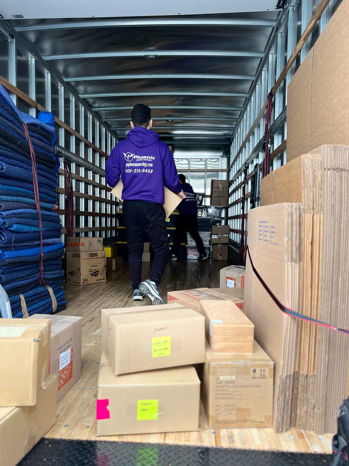 Full Packing Services Two movers packing dishes